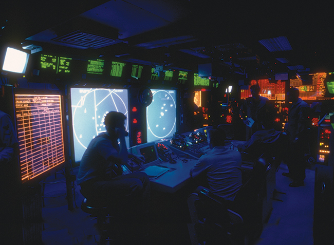 Crew members monitor equipment in the combat information center of the nuclear-powered aircraft carrier USS Abraham Lincoln in the Caribbean Sea. Former Secretary of Defense Ash Carter has said that the US military will never pursue “true autonomy,” meaning humans will always be in charge of lethal force decisions and have mission-level oversight.