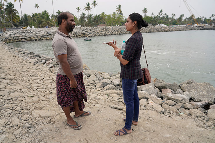 PTI journalist, Lekshmi Gopalakrishnan, out in the field interviewing for her story on the ways in which sea walls can protect locals from devastating cyclones exacerbated by climate change.