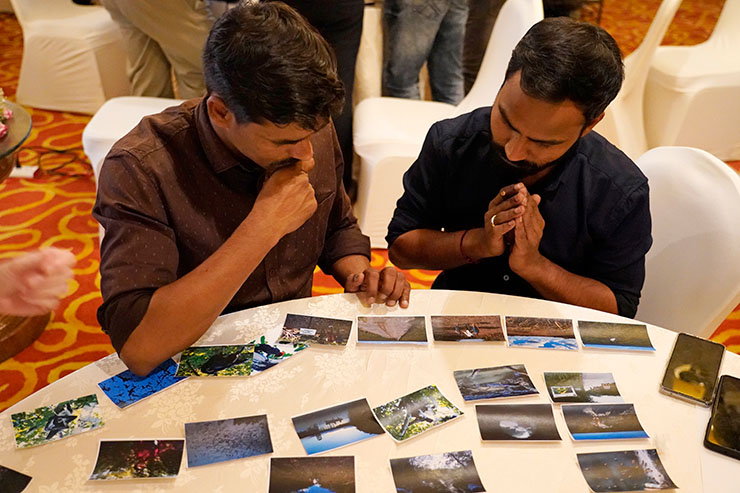 Two PTI journalists during the visual storytelling exercise choose from an array of photos the ones they think should be included in the story.